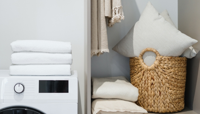 Stash of clean pillows in cupboard next to washer