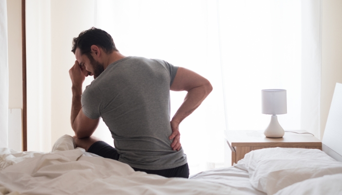 Man waking up with back pain