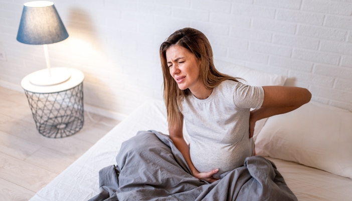 An expecting mom waking up with back pain