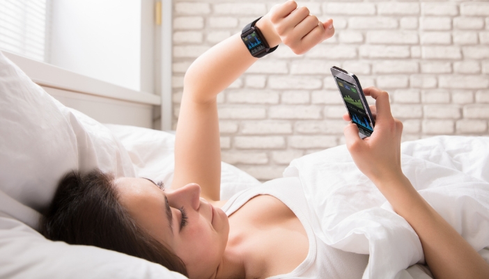 Woman checking her sleep results on her sleep tracker app