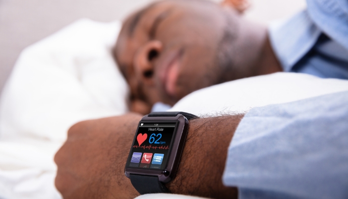 Man sleeping with a smartwatch that is monitoring his sleep