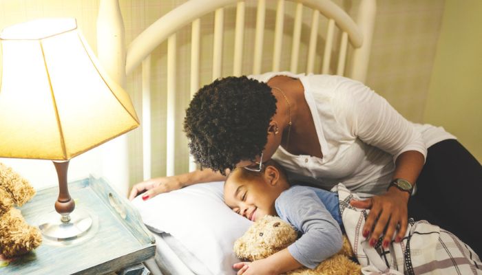 mom kissing son goodnight