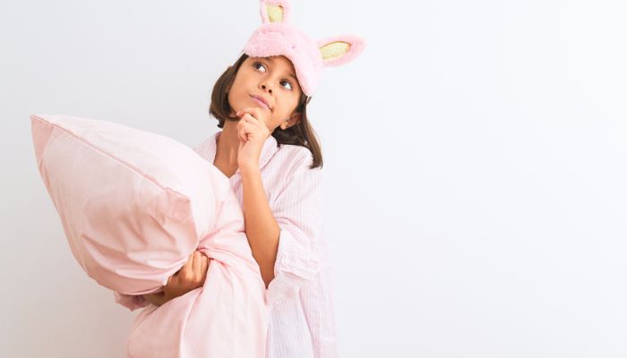 young girl wearing sleep mask