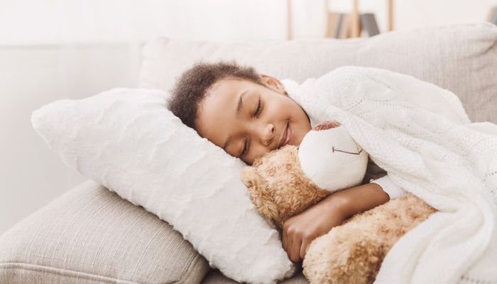little girl sleeping on couch