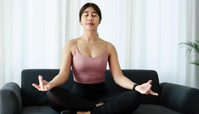 Person meditating on the couch