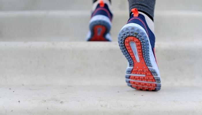 Person wearing sports shoes going up stairs/jogging