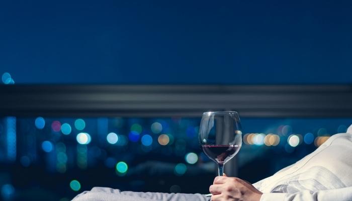 Person relaxing with glass of wine