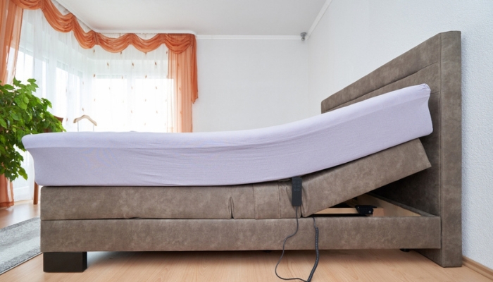 An adustable bed has it’s head side slightly elevated.