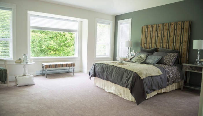 A modern bedroom with a bed on a large bedframe with a foundation