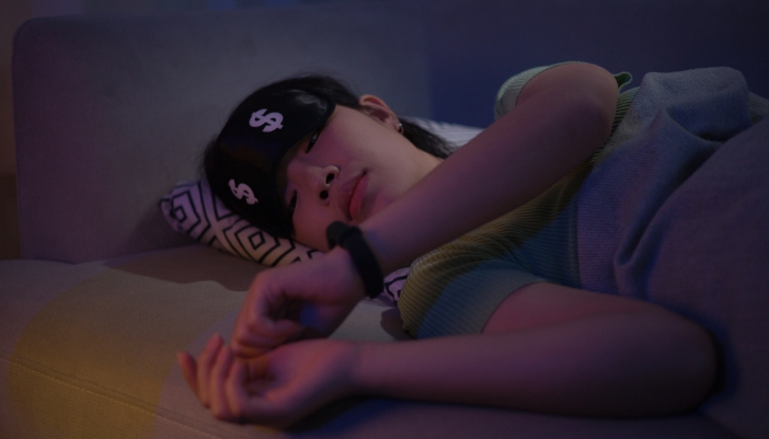 Woman checking her wearable sleep tracker before going to bed
