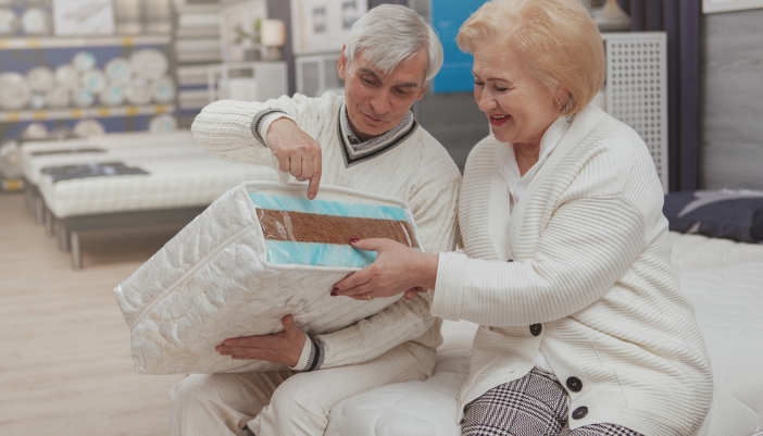 A couple exploring their mattress material options