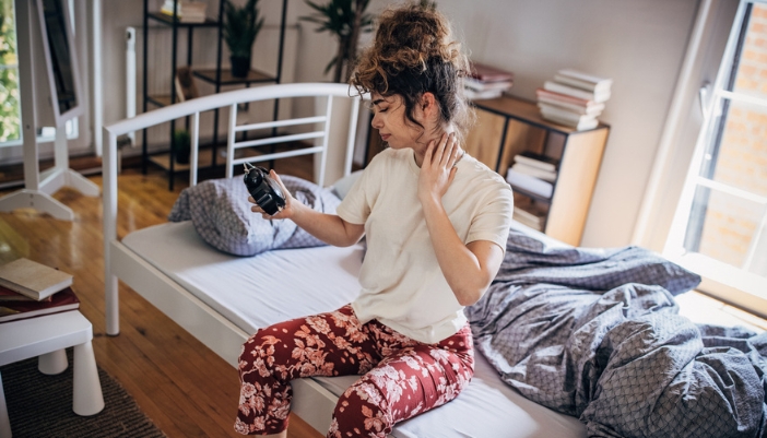 A teenager waking up in the morning with a stiff neck