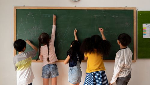 Children Drawing on Chalkboard