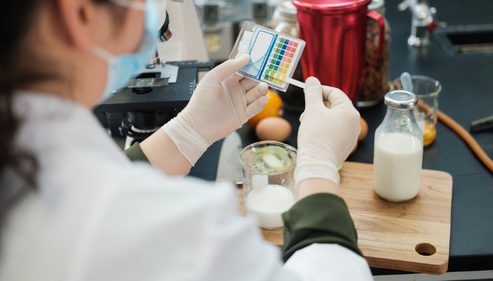 Closeup of a scientist examining milk