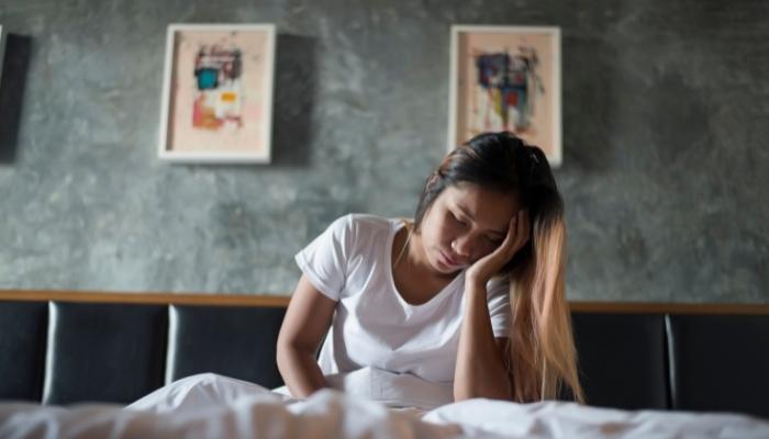 Woman waking up with a headache