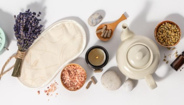 A sleep mask next to array of herbal supplements