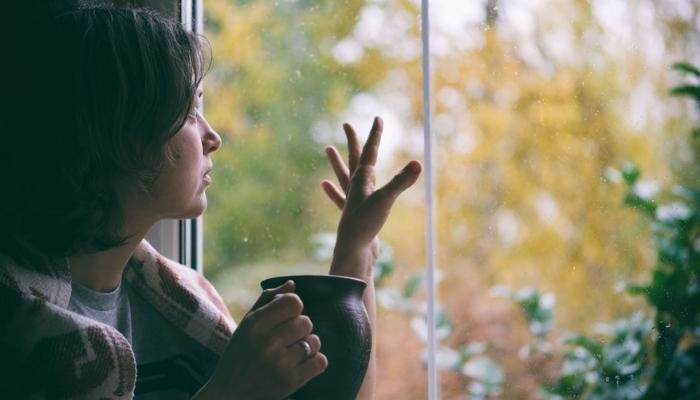 glum woman looking at Fall landscape