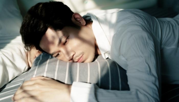 man restless in bed
