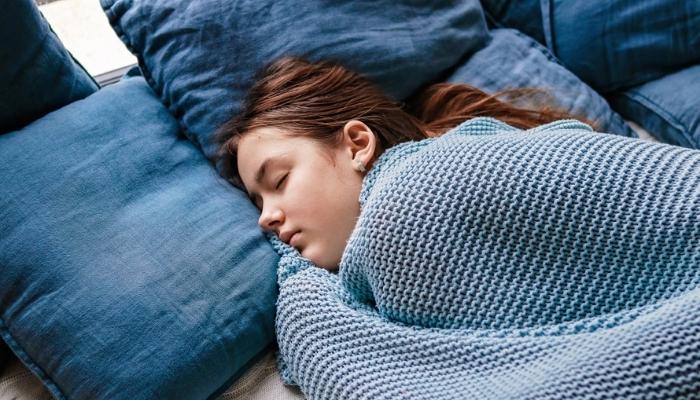 young girl sleep in bed 