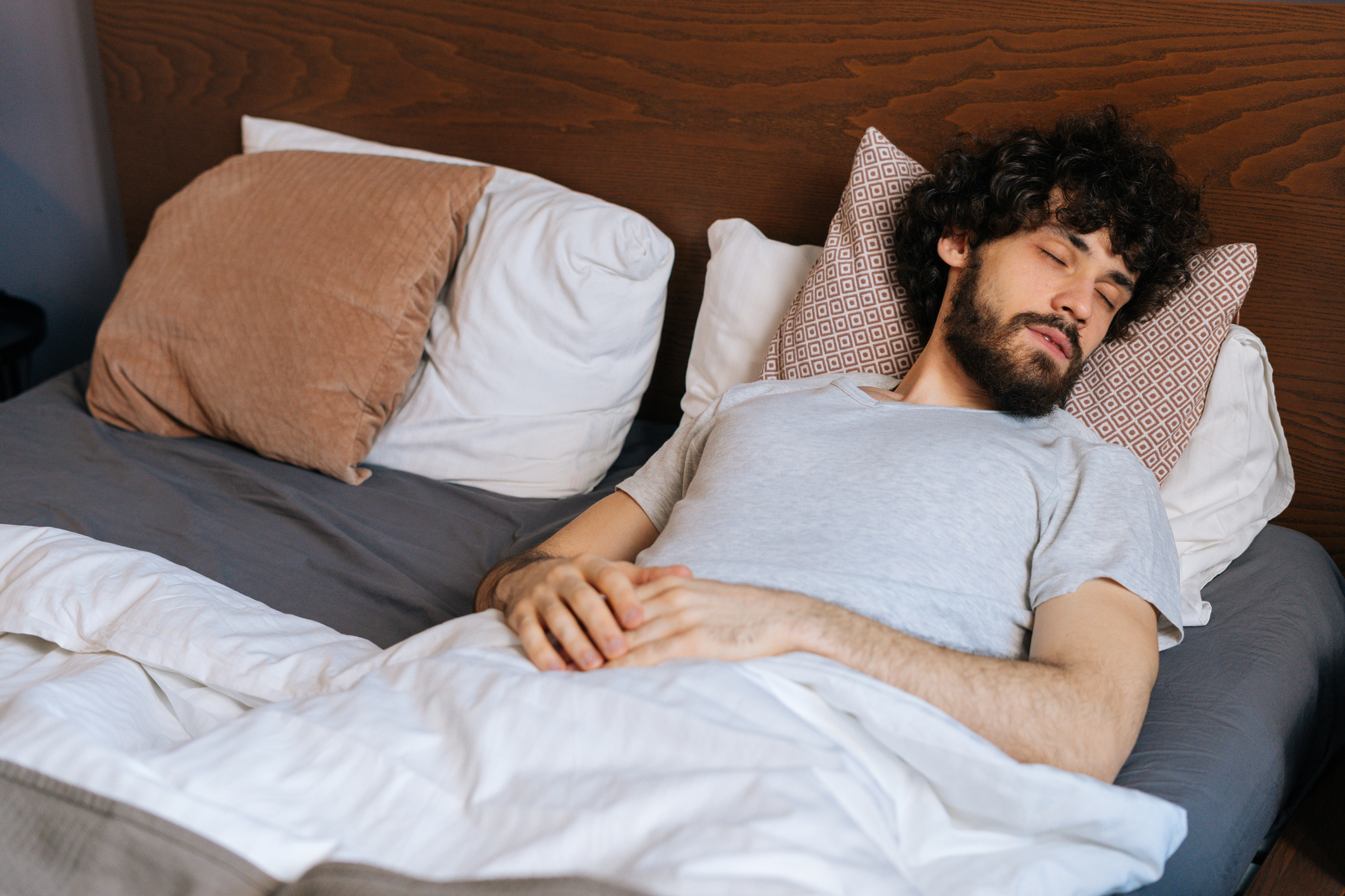man sleeping on back with his head off to the side