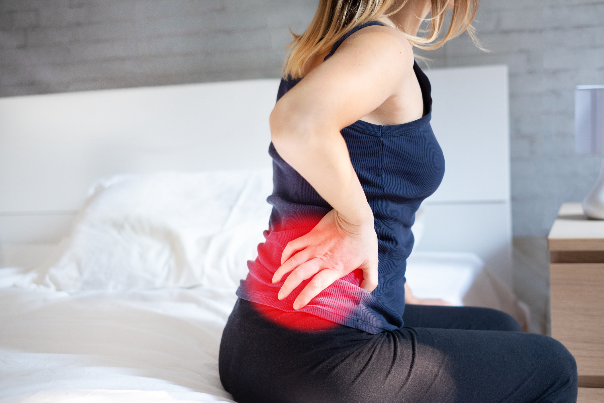 Woman holding highlight pain zone on hip