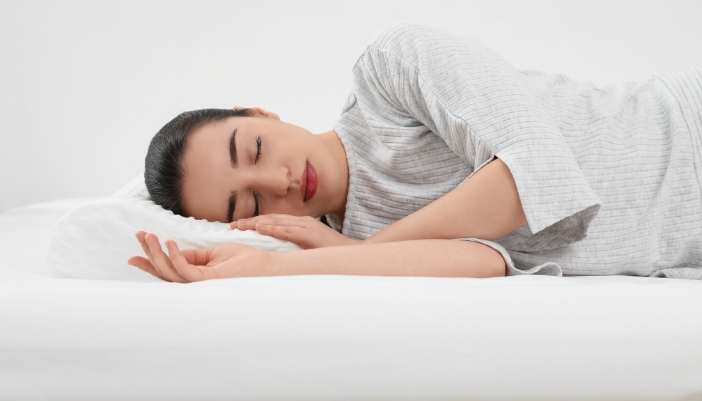 Woman sleeping on a memory foam bed and pillow