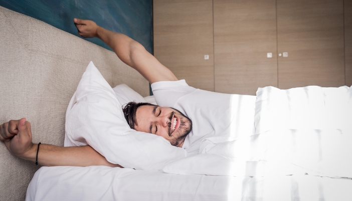 Man waking up refreshed