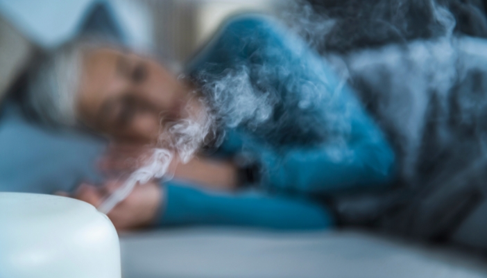 Woman sleeping with a humidifier in the room