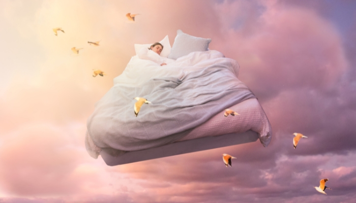 Woman dreaming away in a cloudy dreamscape