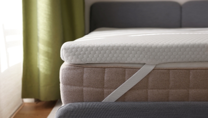 A closeup of a mattress topper on top of a mattress