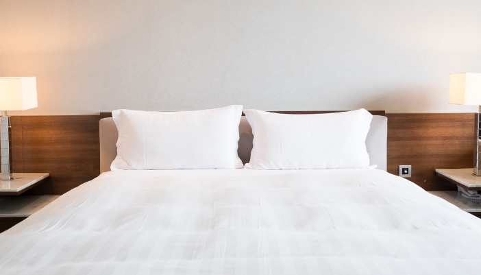 white hotel bed with pillows