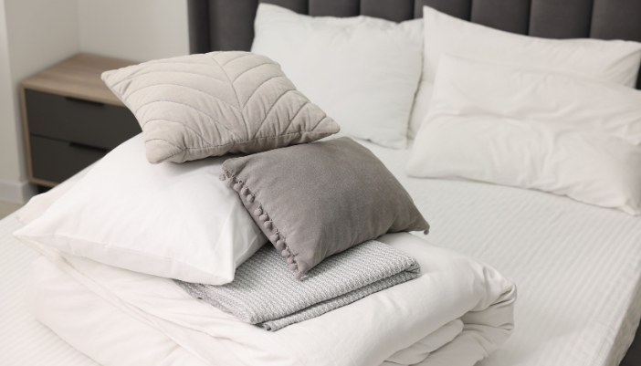 Bed with layers and pillows piled on top