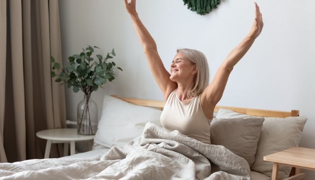 View of a woman waking up comfortably in a memory foam bed