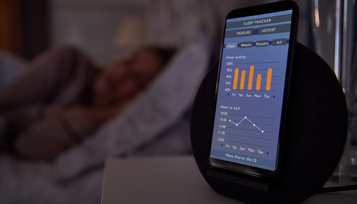 A closeup of a phone featuring a sleep tracking app. 