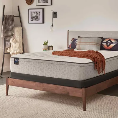 The Sealy Essentials Winter Green mattress in a bedroom 
