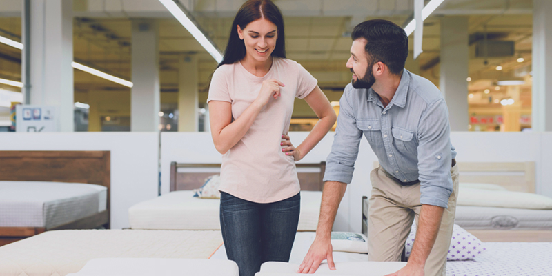 Couple shopping for a new mattress