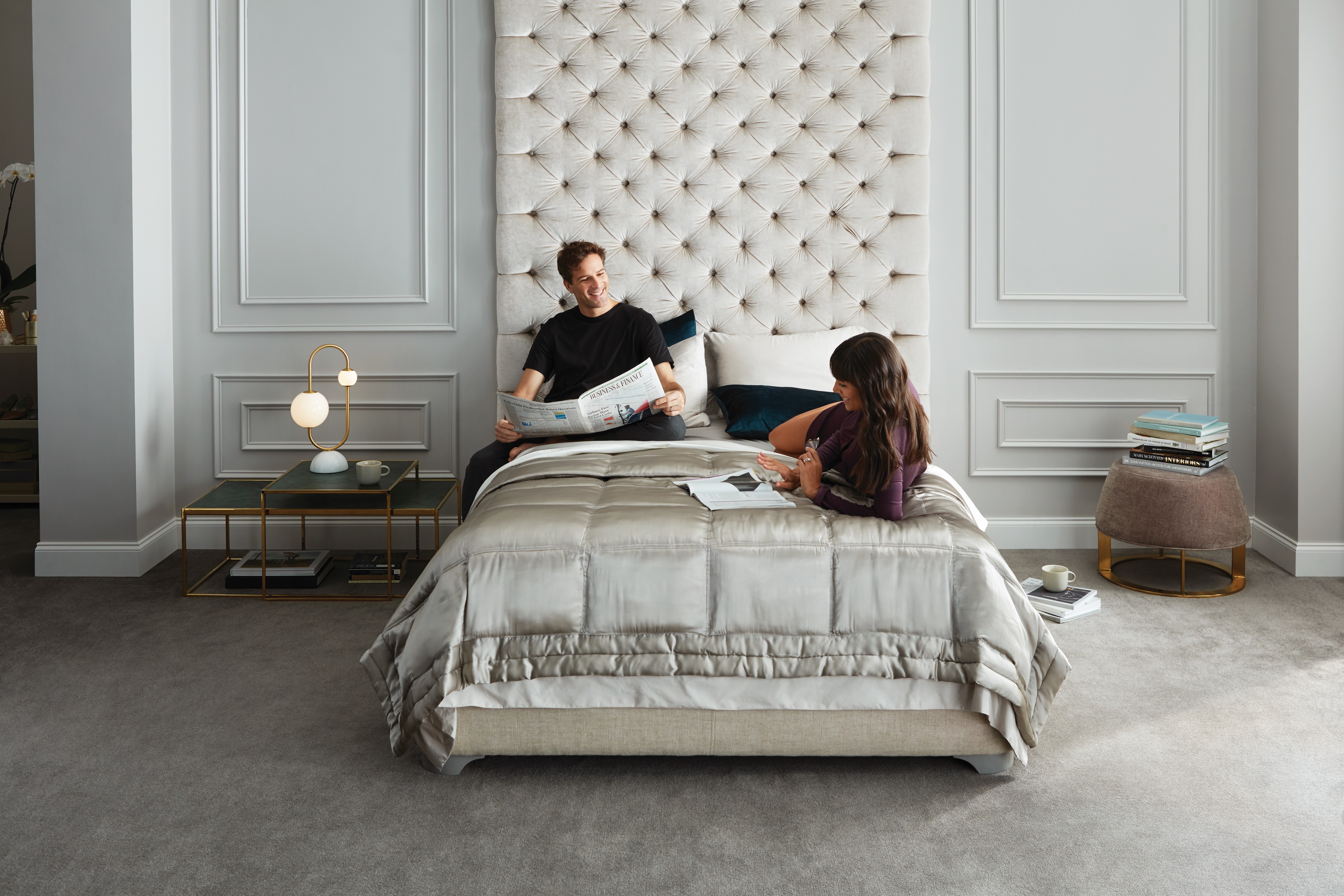 relaxed couple lounges on Beautyrest Black mattress in bedroom