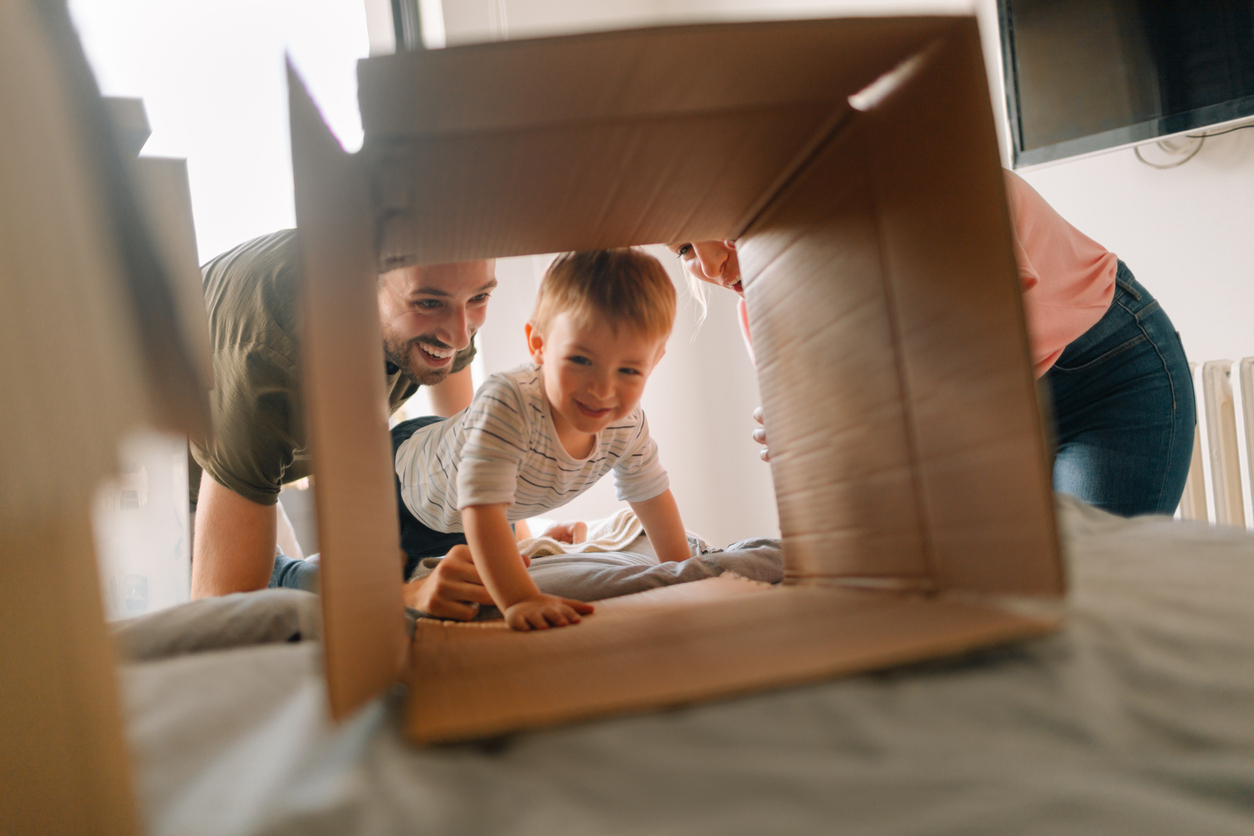 young family with a little boy, being happy and excited about moving into a new home