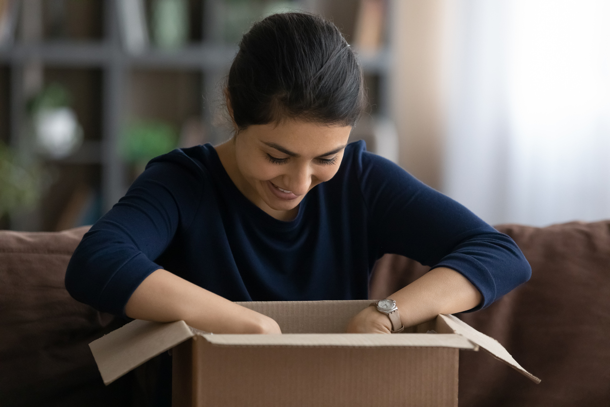 smiling couple relaxing by boxes in their new house