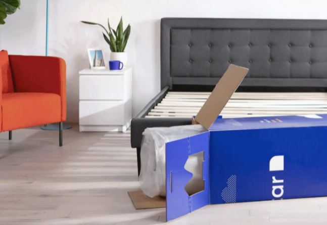 bed in a box next to bedframe