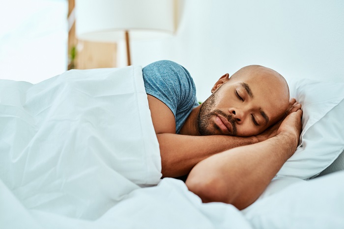 Young man sleeping in his bed.