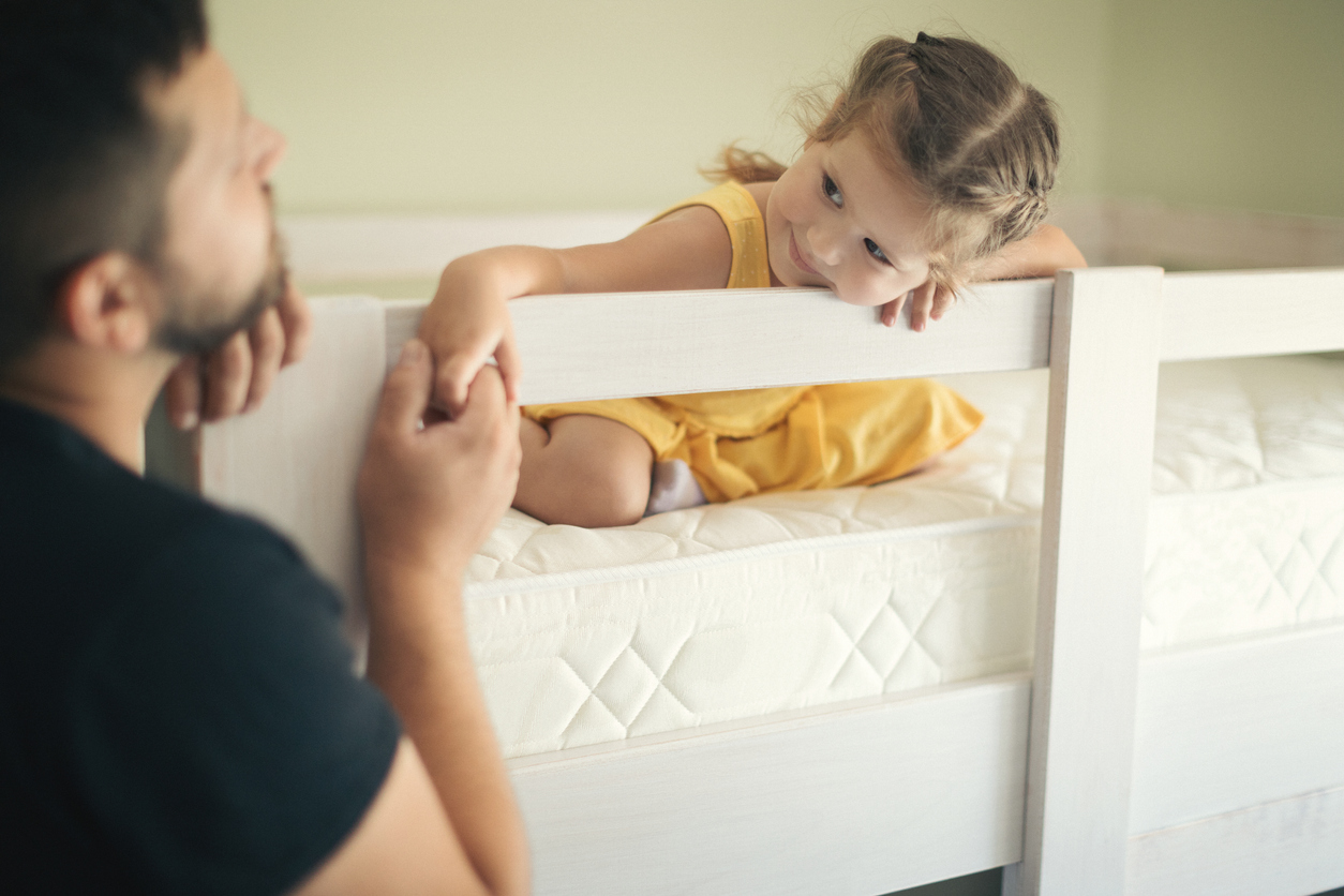 Daughter holds dad’s hand after assembling first big-girl bed