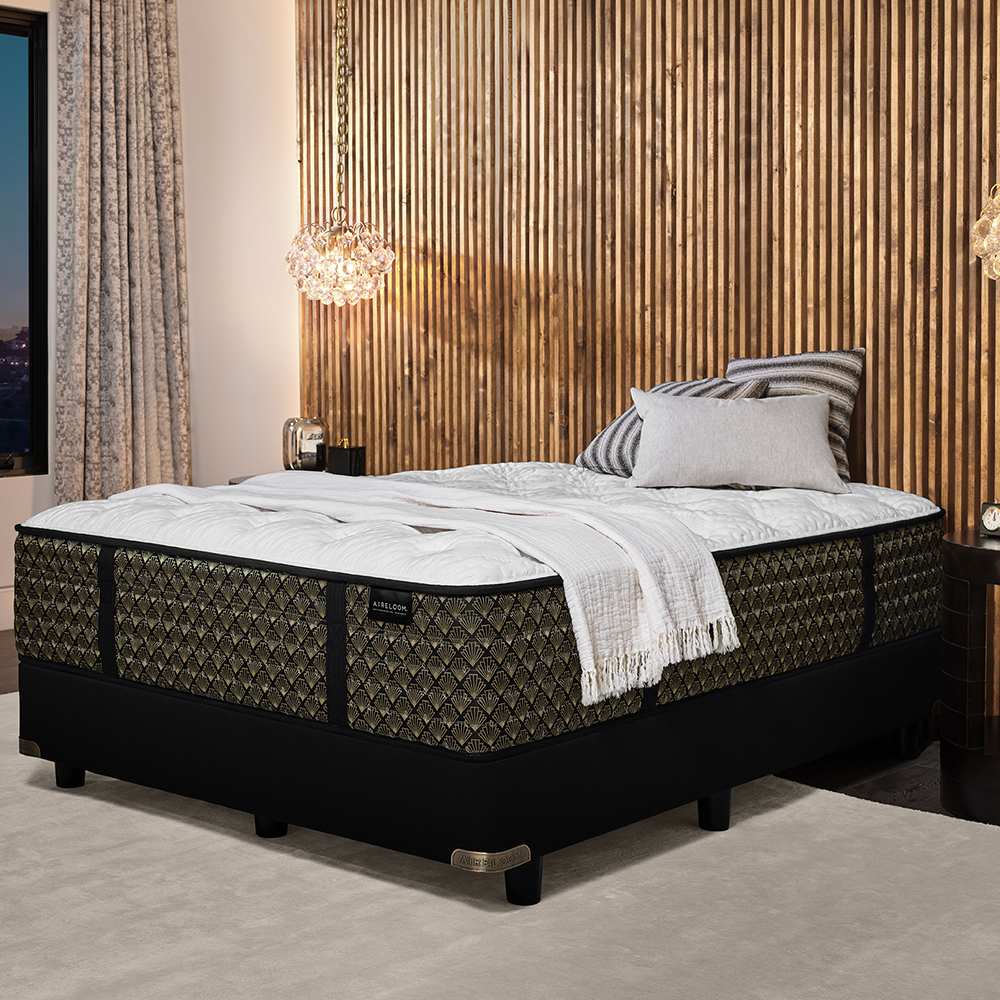 A luxury plush Aireloom mattress in a modern bedroom with chandelier. 