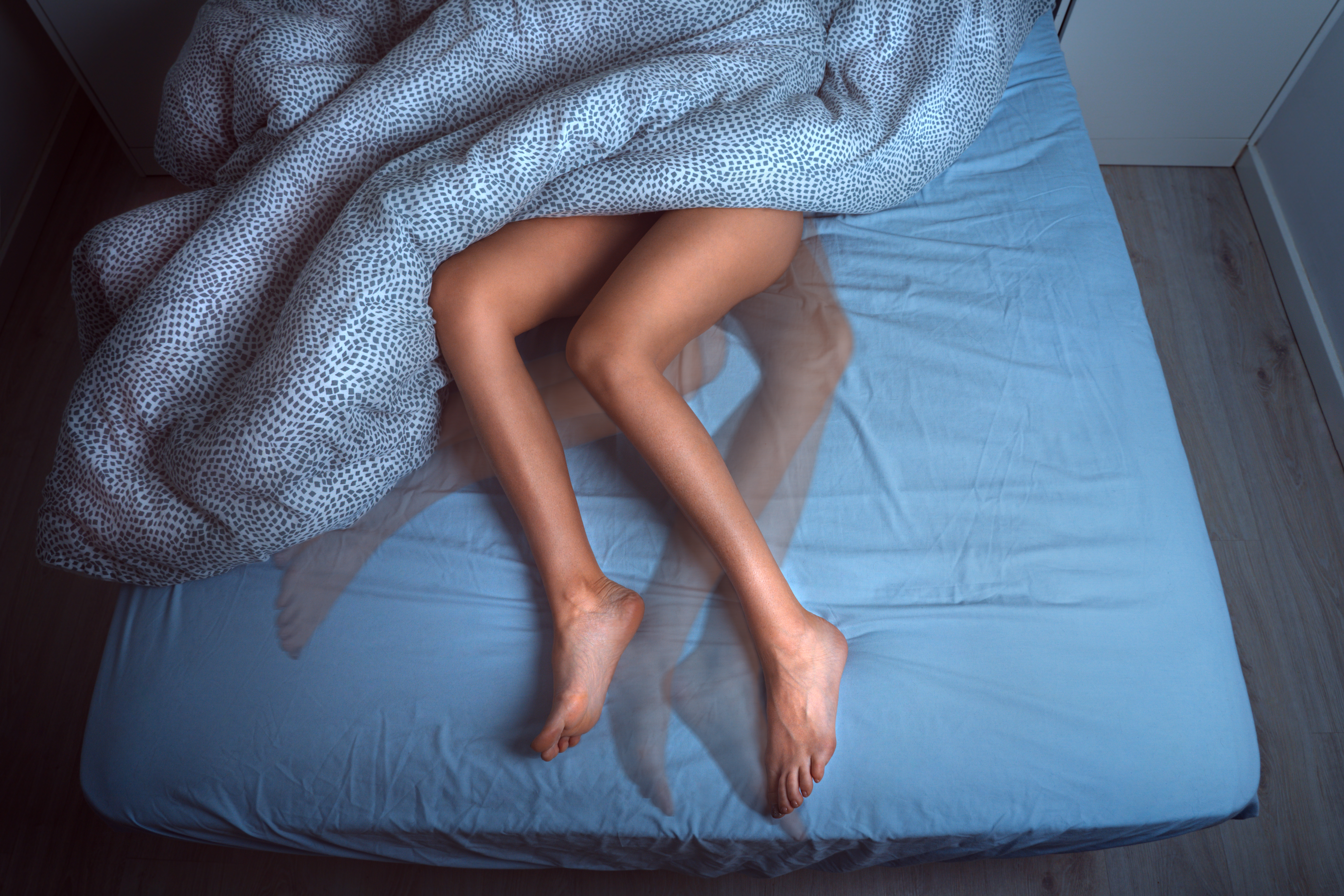 Time lapse of legs moving on a mattress 