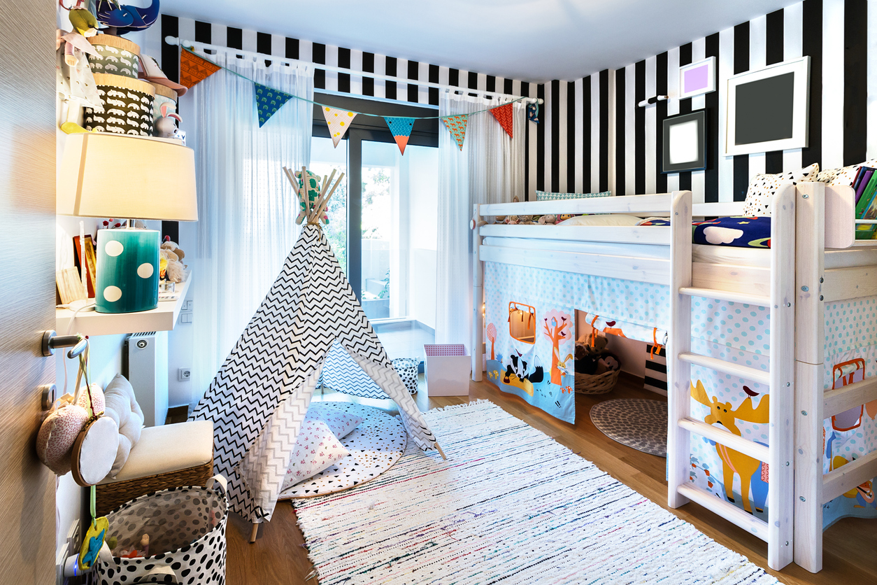 kids’ bedroom with wooden bunk bed, tent, and toys