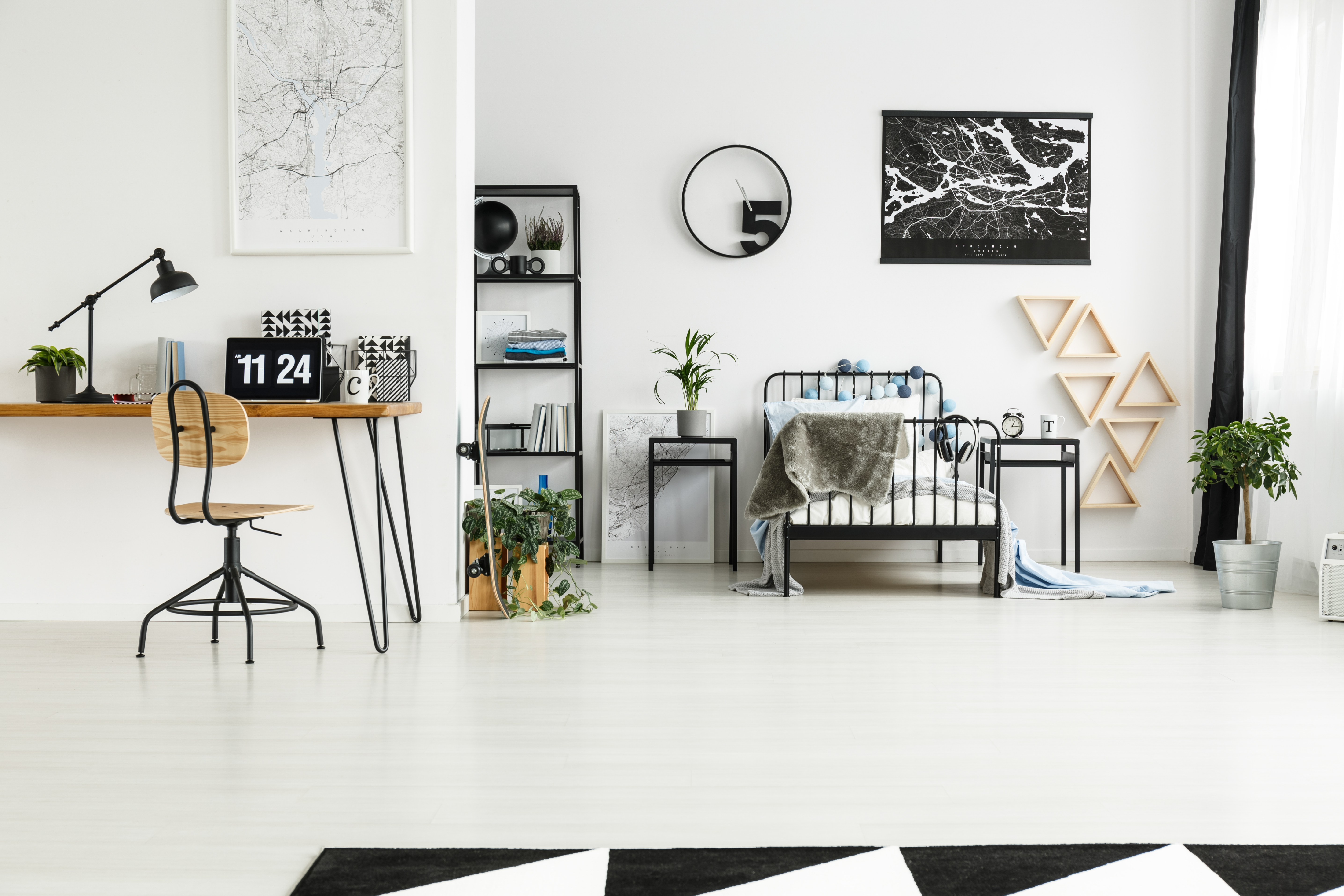 An eclectic bedroom with a black bed frame and accent décor 