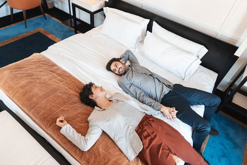 couple on a king size mattress in a store testing it