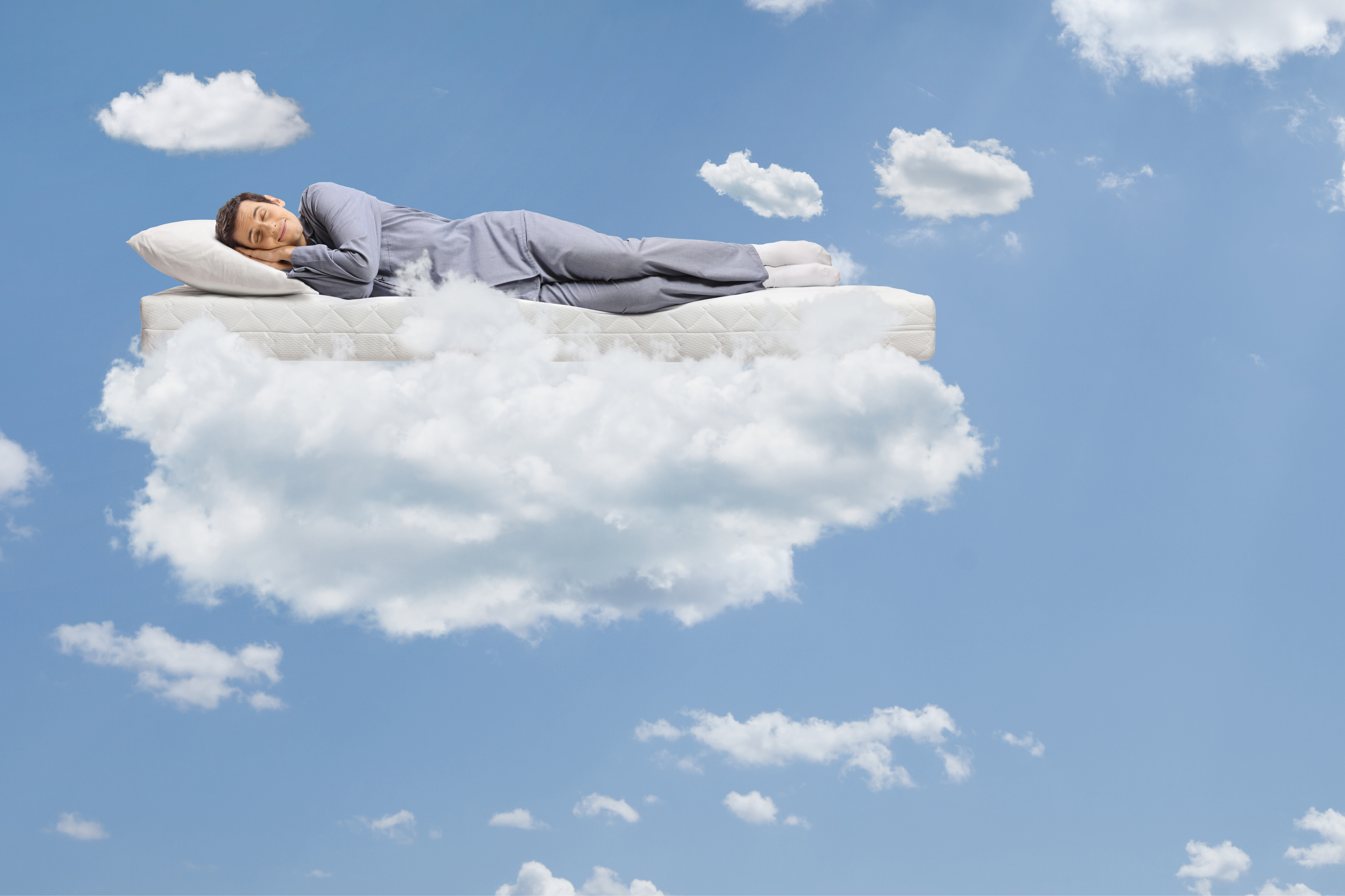 A graphic image of a man sleeping on a cloud 