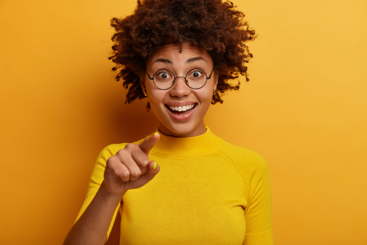 ecstatic woman points finger at camera