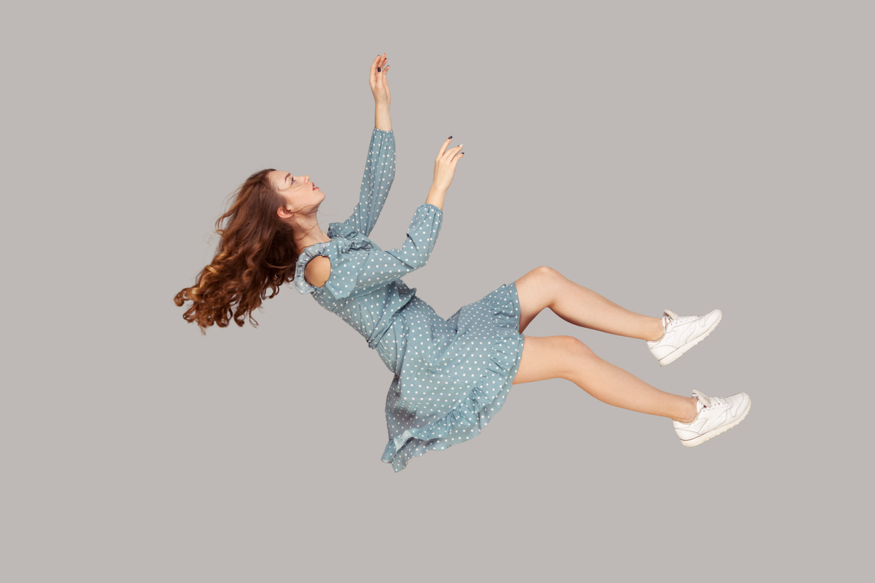 girl ruffle dress and curly soaring hair levitating in a dream